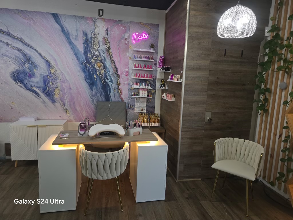 Our nail station with marble mural and neon sign